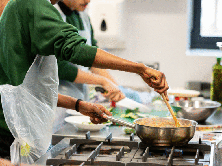 Young Person Cooking Food on a Stove