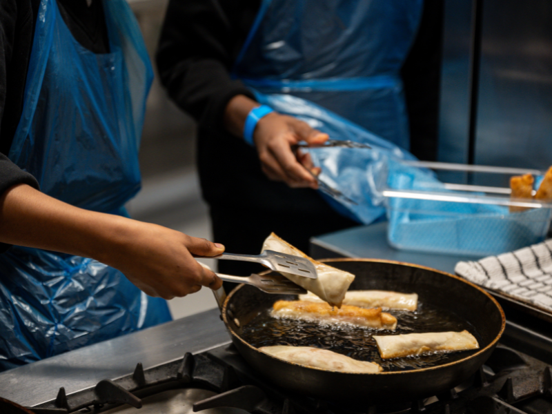Students frying spring rolls